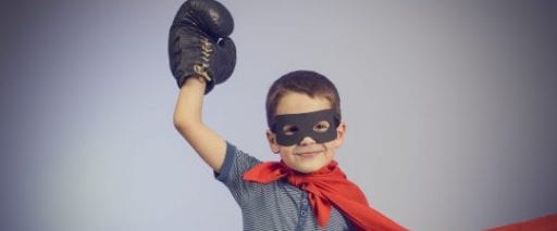A child wearing a boxing glove and super hero costume to represent how Gorvins solicitors battle to win their dispute resolution cases